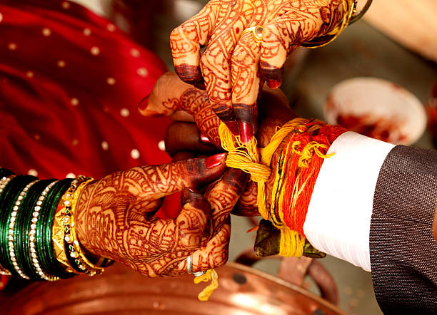 Part of an indian hindu wedding ceremony where the bride and grooms are tied wedding band together