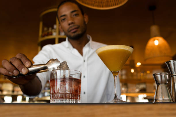 istock latin bartender putting ice on the cocktail 1539402114