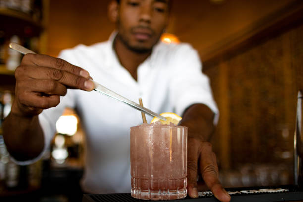 istock latin bartender putting a slice of lemon on the cocktail 1539407340