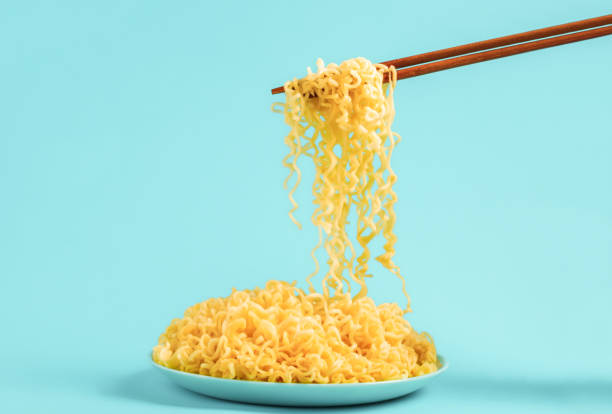 istock Egg noodles on blue plate with chopsticks on blue background 1539416735