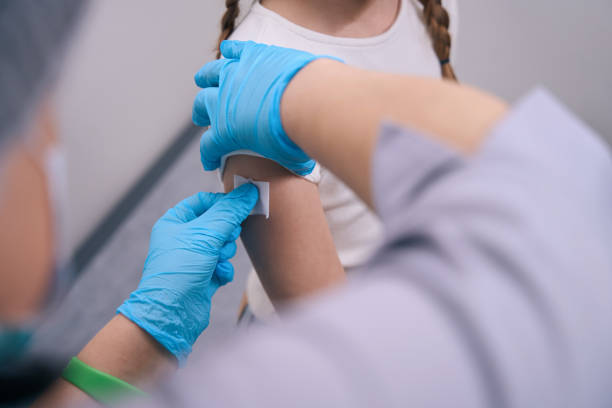 istock Nurse glues a patch after an injection on girls hand 1539470501