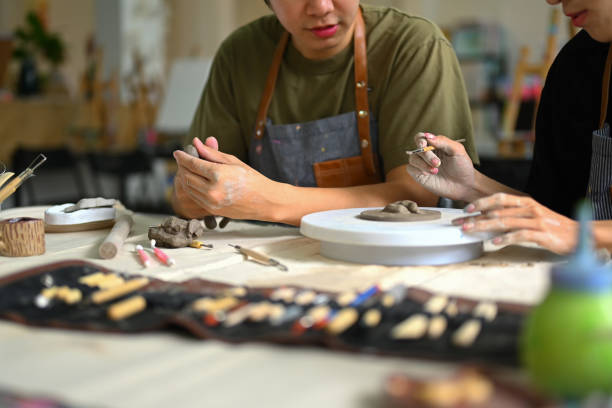 istock Man modeling clay in pottery workshop, creative activity, handicraft and hobbies concept. 1539496221
