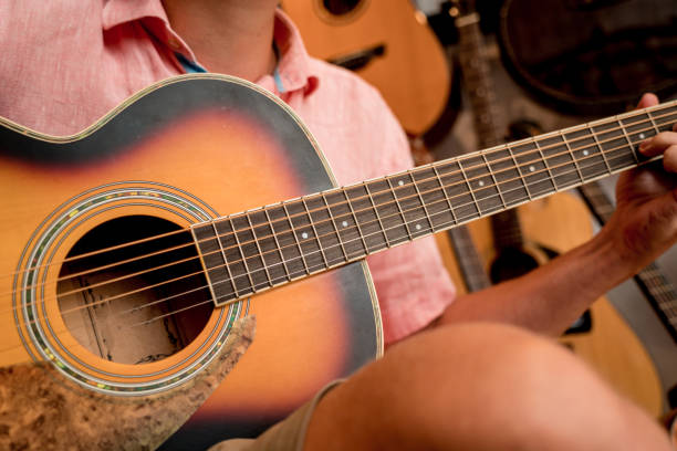 istock Young musician testing classical guitar in a guitar shop 1539525300