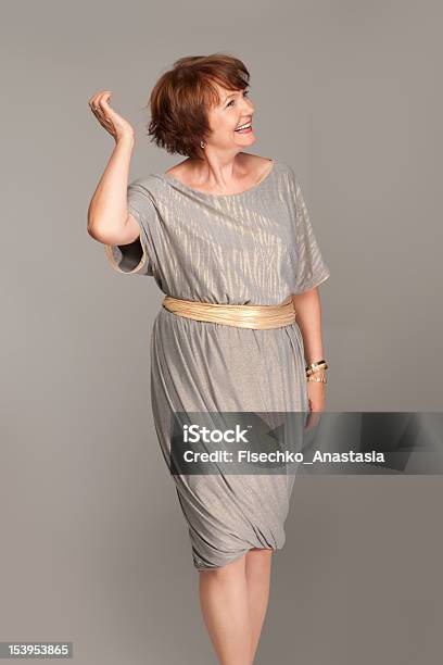 Beautiful Fashionable Mature Woman In Grey Dress Studio Shot Stock Photo - Download Image Now