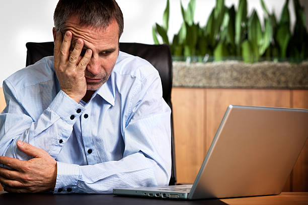 istock Frustrated businessman at laptop. 153954055