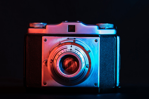 Close-up photo of  a Vintage Camera with colorful lighting