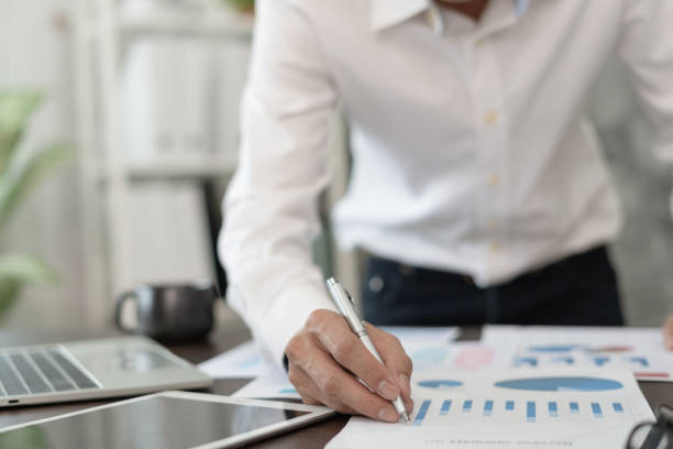 istock Business men calculate benefit, spreadsheets, graph financial development, bank accounts, statistics, economy, data analysis, investment analysis, stock exchange,Interest rates, income 1539546110