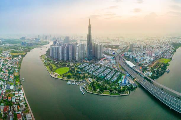 Aerial view of a Ho Chi Minh City, Vietnam with development buildings, transportation, energy power infrastructure. Financial and business centers. Sunset to night. Aerial view of a Ho Chi Minh City, Vietnam with development buildings, transportation, energy power infrastructure. Financial and business centers. Sunset to night. Travel and landscape concept. vietnamese economy stock pictures, royalty-free photos & images