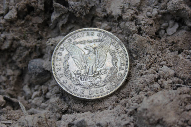 istock 1879 Morgan Silver Dollar On Ground in Dirt Back View 1539571891