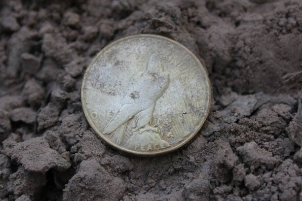 istock 1922 Silver Peace Dollar On Ground in Dirt. Back View 1539572117