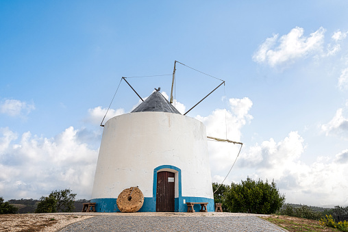 Front view of traditional blue white portuguese windmill in Odeceixe, Costa Vicentina, Portugal.