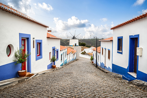 Odeceixe Village with traditional windmill at the end of the street. Vicentine coast, Algarve, Portugal