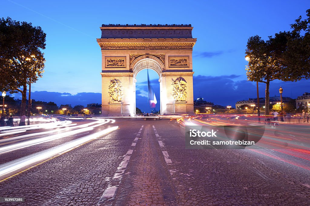 Evening traffic on Champs-Elysees Evening traffic on Champs-Elysees in front of Arc de Triomphe (Paris, France). Long exposure evening shot. Arch - Architectural Feature Stock Photo