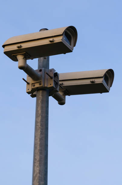 istock Surveillance cameras mounted on a pole against the blue sky. 1539580150