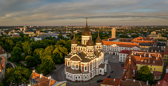 Old Town of Tallinn with famous Alexander Nevsky Cathedral at Sunrise during early midsummer twilight. Tallinn Old Town Cityscape of Toompea Hill Panorama. Aerial view towards St. Alexander Nevski Cathedral and surrounding old toen streets and buildings to the city horizon.. Mavic 3 Pro Stitched Panorama. Alexander Nevsky Cathedral, Toompea Hill, Old Town Tallinn, Estonia, Baltic Countries, Europe