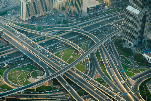 Aerial view of Dubai highways with cars and metro train
