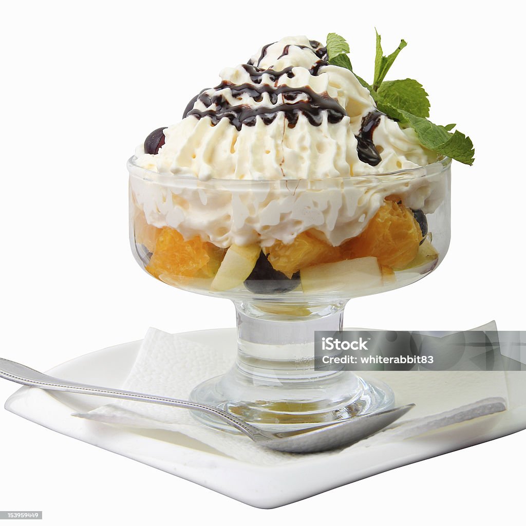 fruit salad fruit salad with crem and mint twig in the glass bowl isolated on a white background Appetizer Stock Photo