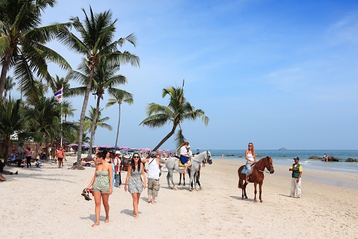 People visit sandy beach in Hua Hin, Thailand. Hua Hin is one of most popular resorts in Thailand with a significant retiree population.