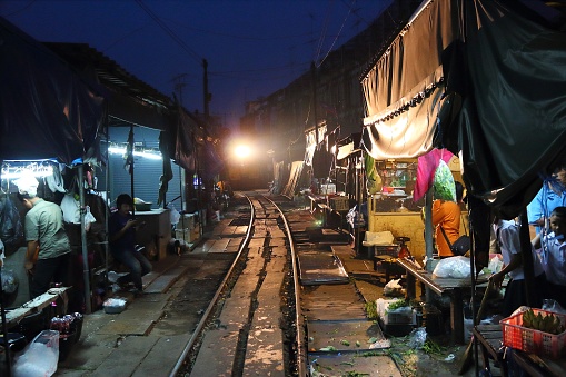 Train rides through Mae Klong market in Thailand. The market is notable for its location on active railroad line.