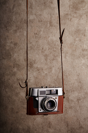 Analog vintage 35mm  film camera hanging on its strap