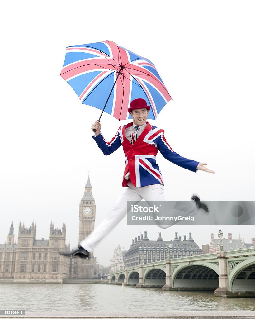 Jumping British Man in London with Big Ben Patriotic British man in Union Jack clothing jumping by the Thames British Flag Stock Photo