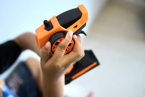 Close-up of a boy's hands holding a toy remote control stock photo