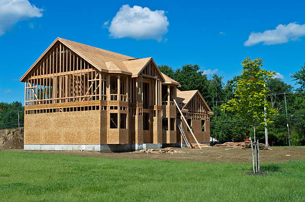 New home under construction with green lawn stock photo
