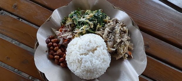 Nasi Campur Bali. Balinese dish of steamed rice with variety of side dishes. popular traditional Balinese meal.
