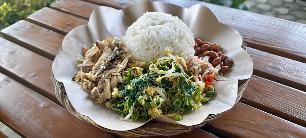 Nasi Campur Bali. Balinese dish of steamed rice with variety of side dishes. popular traditional Balinese meal.