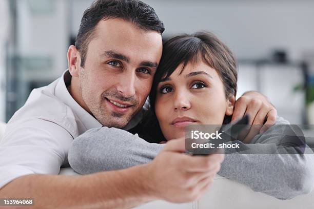 Relaxed Young Couple Watching Tv At Home Stock Photo - Download Image Now - Adult, Adults Only, Arts Culture and Entertainment