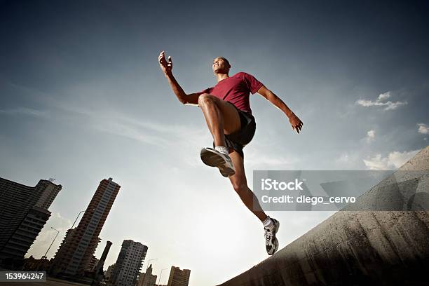 Hispanic Man Running And Jumping From A Wall Stock Photo - Download Image Now - Low Angle View, Running, Jumping