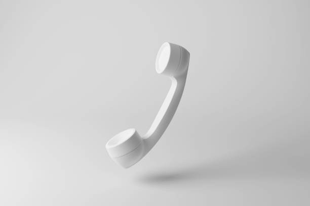 White handset floating in mid air on white background in monochrome and minimalism. Illustration of the concept of communication and business cold calls