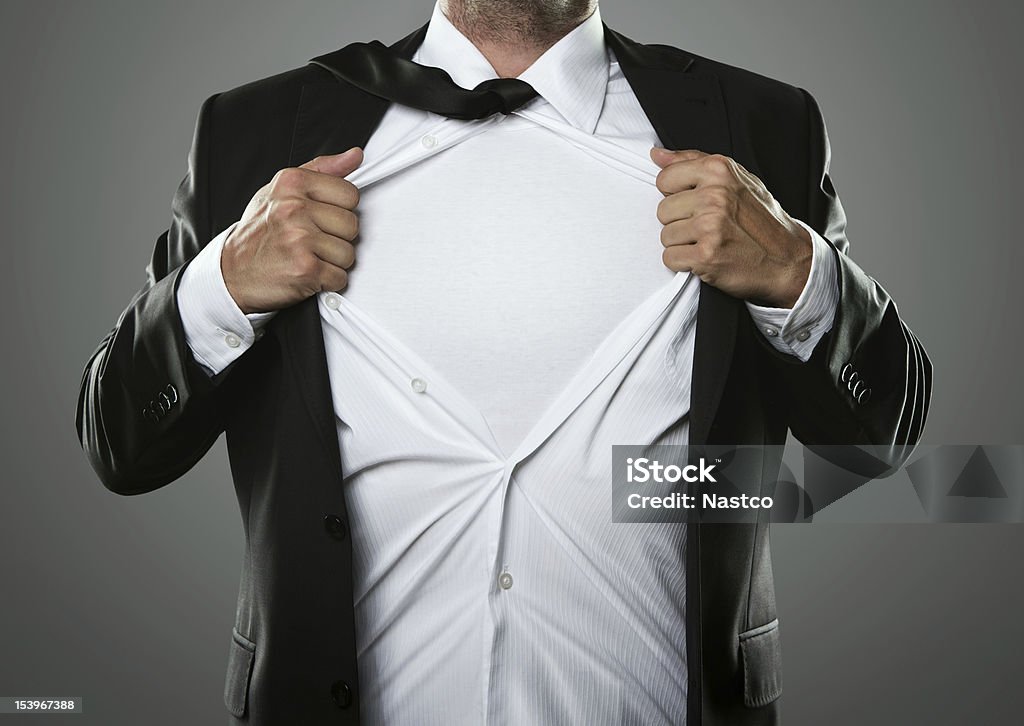 Superhero Young businessman acting like a super hero and tearing his shirt off with copy space Shirt Stock Photo