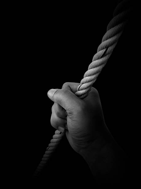 istock Man's hand holding on to the rope. On a white background 1539676503