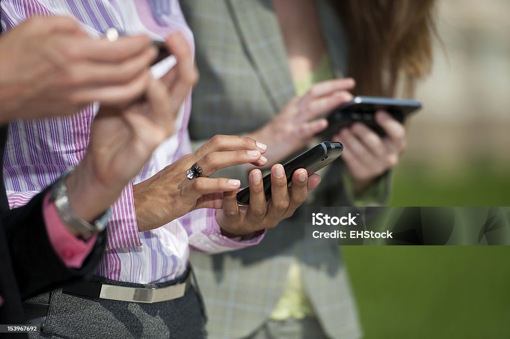 Three Businesswomen Texting Adult Stock Photo