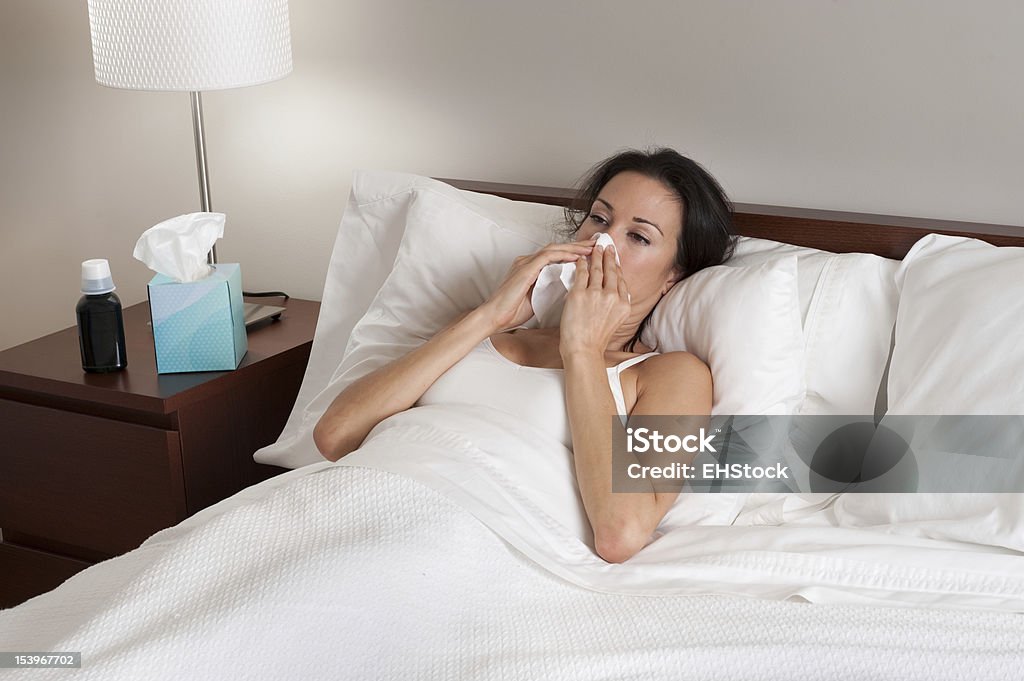 Sick Woman in Bed Blowing Nose Adult Stock Photo