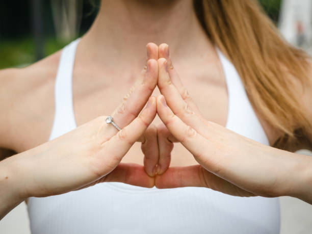 istock young woman practicing yoga and making yoga mudras with her hands 1539679231