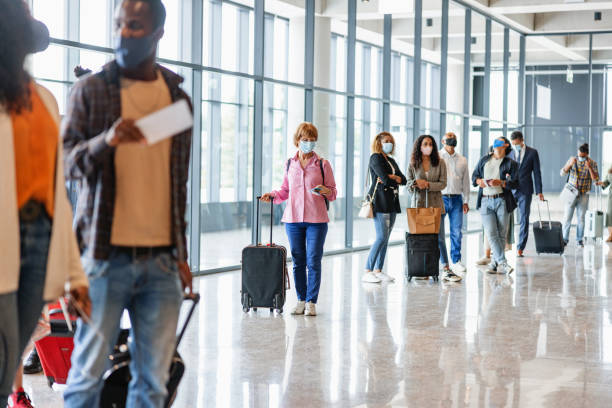 istock Group Of Multi Ethnical Passenger Standing In A Queue With Mask On 1539686114