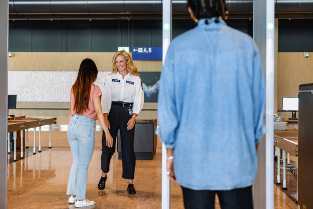 istock Airport Security Screening: Friendly Staff Ensuring Safety 1539686125