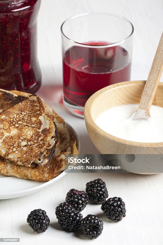 Pancakes and blackberries Plate of pancakes with fresh blackberries and glass of juice Berry Fruit Stock Photo