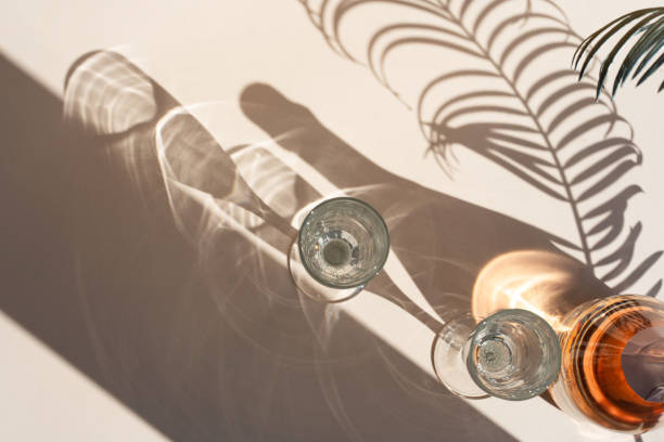 istock Different glasses for wine, cocktails, drinks, long sun shadow on a light beige background. The concept of wine tasting or summer vacation. 1539692537