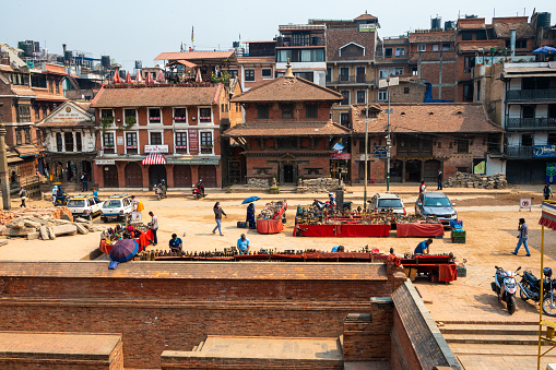 Lalitpur, Nepal - Apr 17, 2023: A landscape around Patan Durbar Square with tourists and locals walking and sightseeing around. Located in the city of Lalitpur, Kathmandu Valley, Nepal.