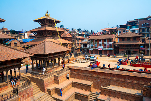 Lalitpur, Nepal - Apr 17, 2023: A landscape around Patan Durbar Square with tourists and locals walking and sightseeing around. Located in the city of Lalitpur, Kathmandu Valley, Nepal.