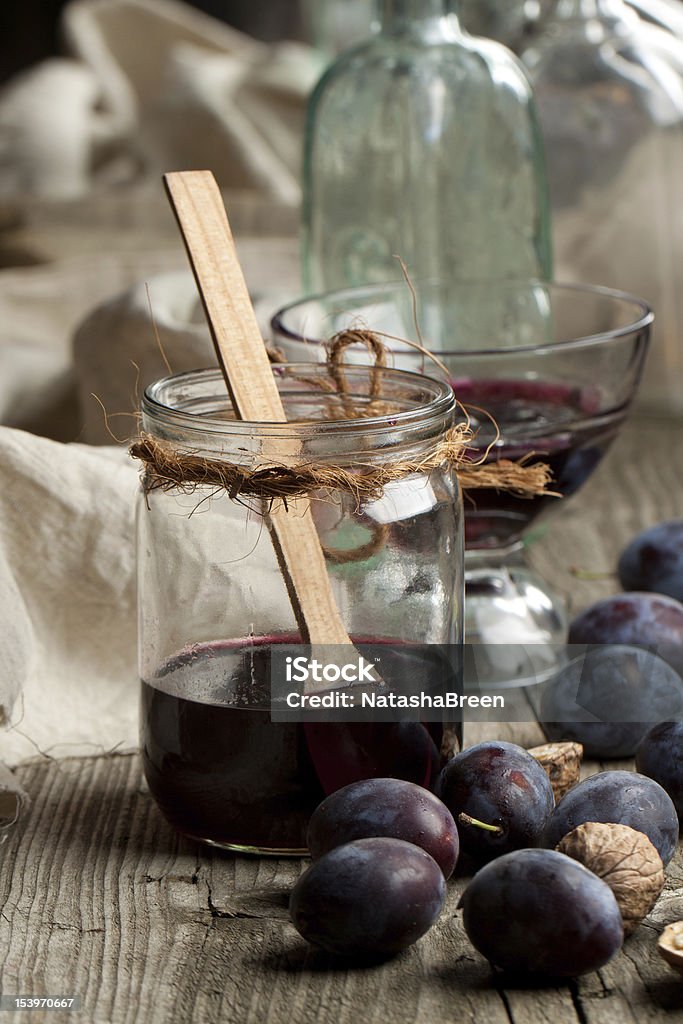 Jam in jar Jam in jar and fresh plums on old wooden table Breakfast Stock Photo