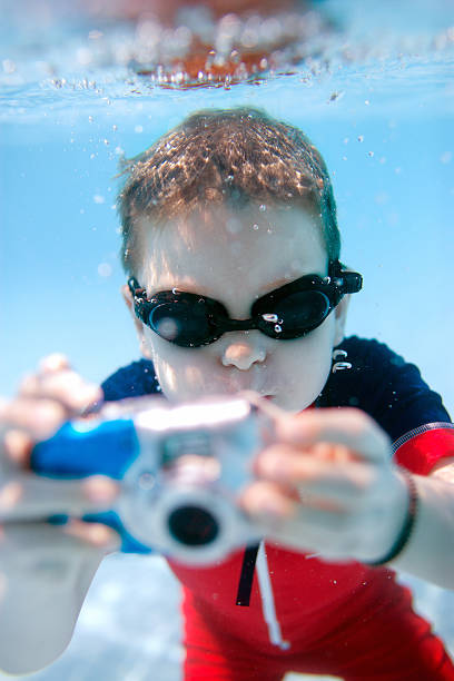 istock Little boy swimming underwater 153971186