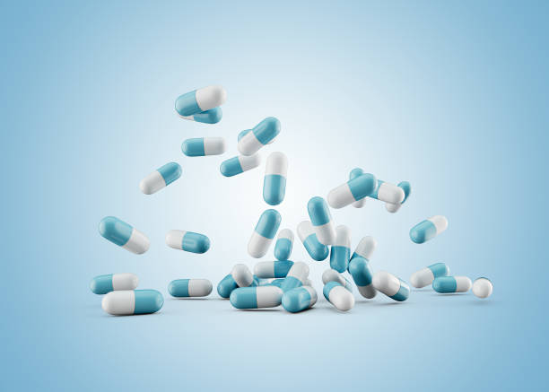 istock 3d Blue And White Pharmaceutical Antibiotic Capsules Falling On Soft Blue Background 3d Illustration 1539716213