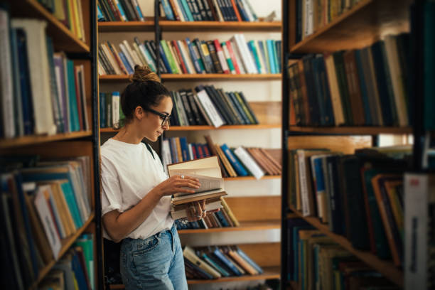 istock A student stuying and reading books in a public library. 1539721414
