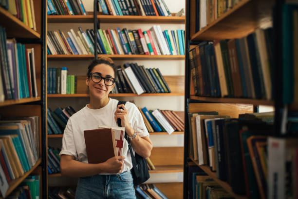 istock A student stuying and reading books in a public library. 1539721416