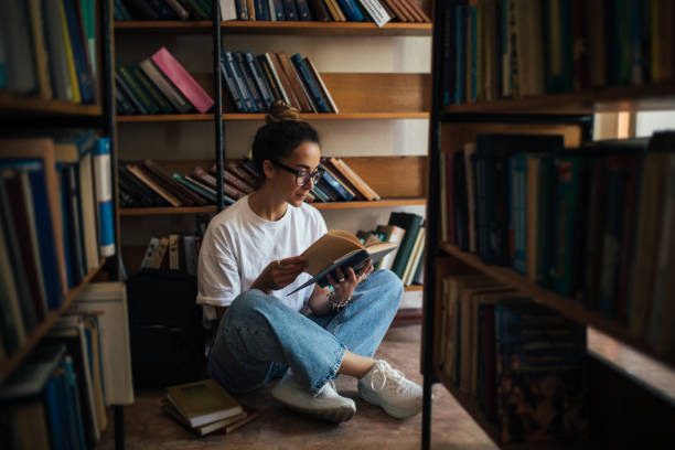 istock A student stuying and reading books in a public library. 1539721418
