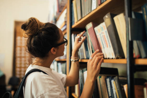 istock A student stuying and reading books in a public library. 1539721422